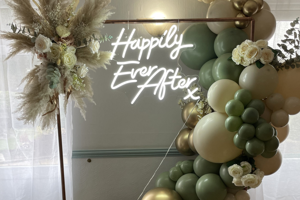 Balloon Arch with neon sign that says "Happily Ever After"